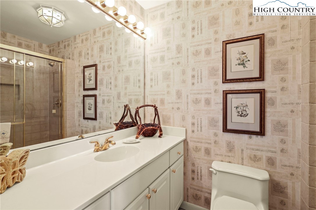 8015 Cloud Forest Lane Blowing Rock, NC 28605 - Photo 18 of 23 a bathroom with a sink toilet and shower