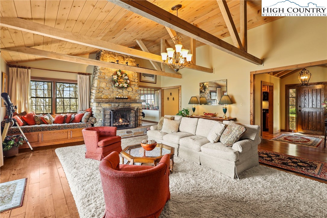 8015 Cloud Forest Lane Blowing Rock, NC 28605 - Photo 6 of 23 a living room with furniture a fireplace and a large window