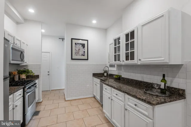 a kitchen with sink and window