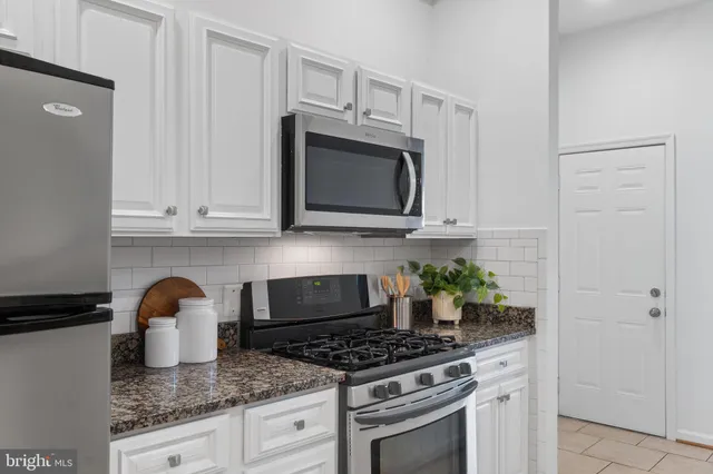 a kitchen with counter top space cabinets and stainless steel appliances
