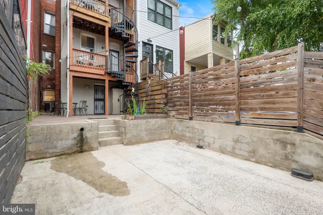 a view of a hallway with wooden shelves