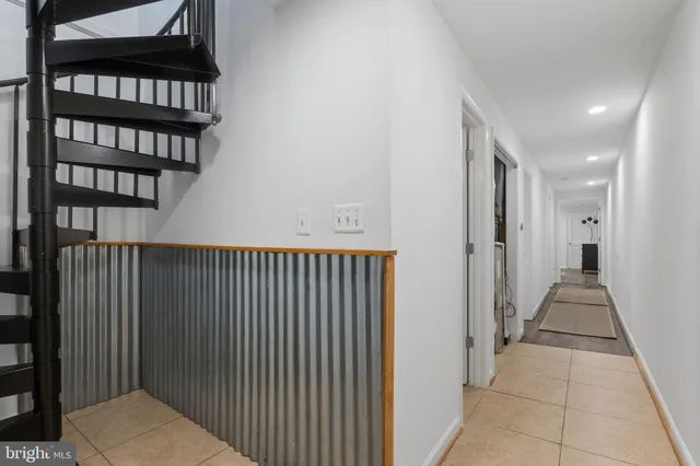 a bedroom with a bed and painting on the wall