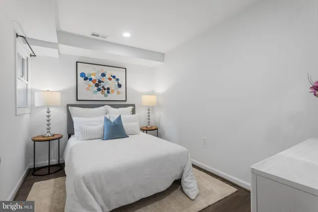 a bedroom with a bed and a dresser