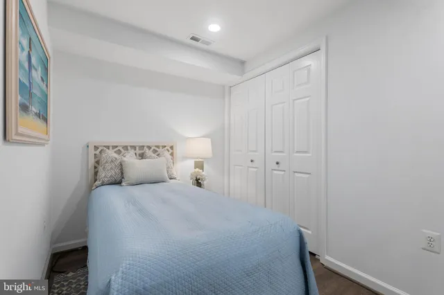 a bedroom with a bed and a night stand