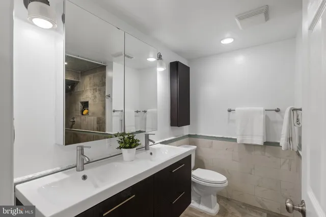 a bathroom with a sink double vanity and a mirror