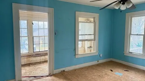 a bathroom with a window and a shower