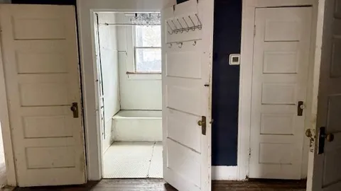 a kitchen with granite countertop white cabinets and a sink