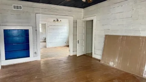 a view of empty room with a fireplace