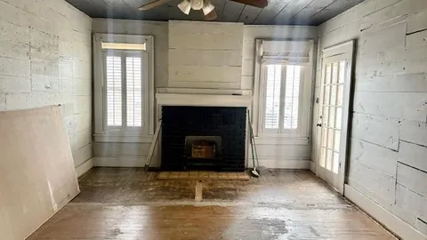 a bathroom with a granite countertop sink and a window