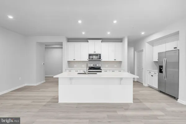a kitchen with a sink a stove and refrigerator
