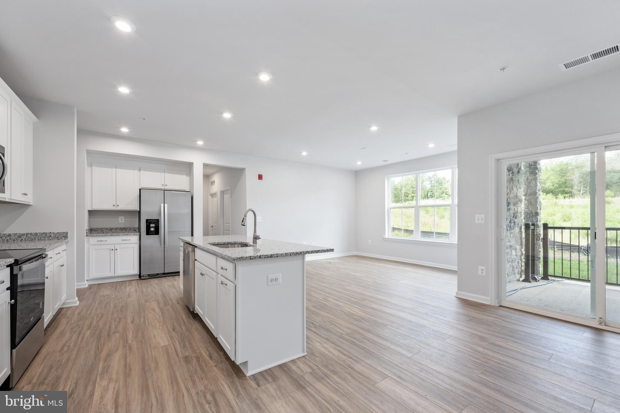 29 Hyssop Way, Unit 103 Stafford, VA 22554 - Photo 15 of 39 a large kitchen with stainless steel appliances granite countertop a large center island and a wooden floors