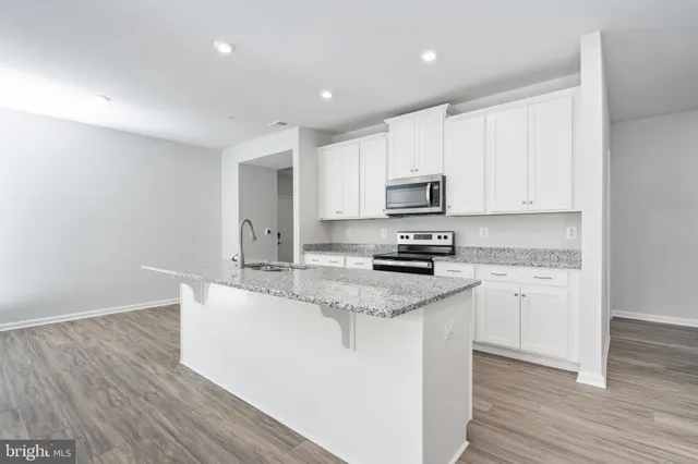 a view of a room with wooden floor and sink