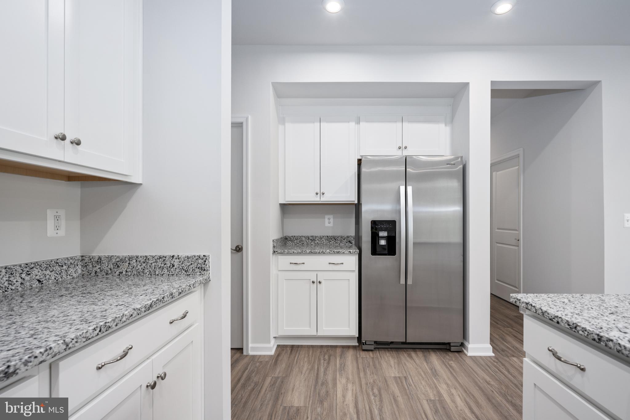 29 Hyssop Way, Unit 103 Stafford, VA 22554 - Photo 23 of 39 a kitchen with granite countertop a refrigerator and a sink