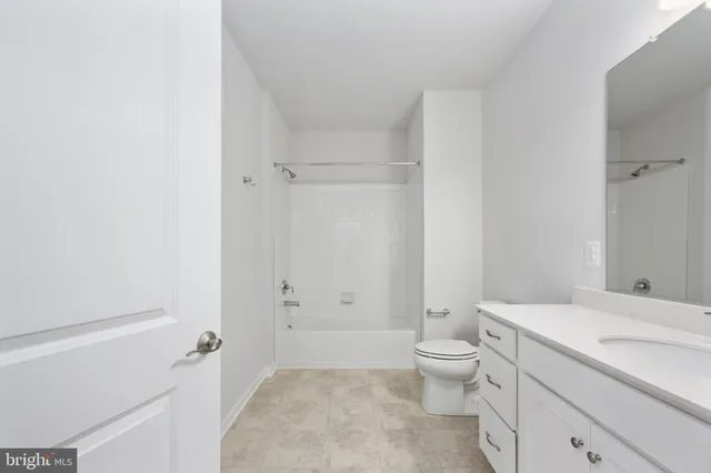 a spacious bathroom with a toilet sink and mirror
