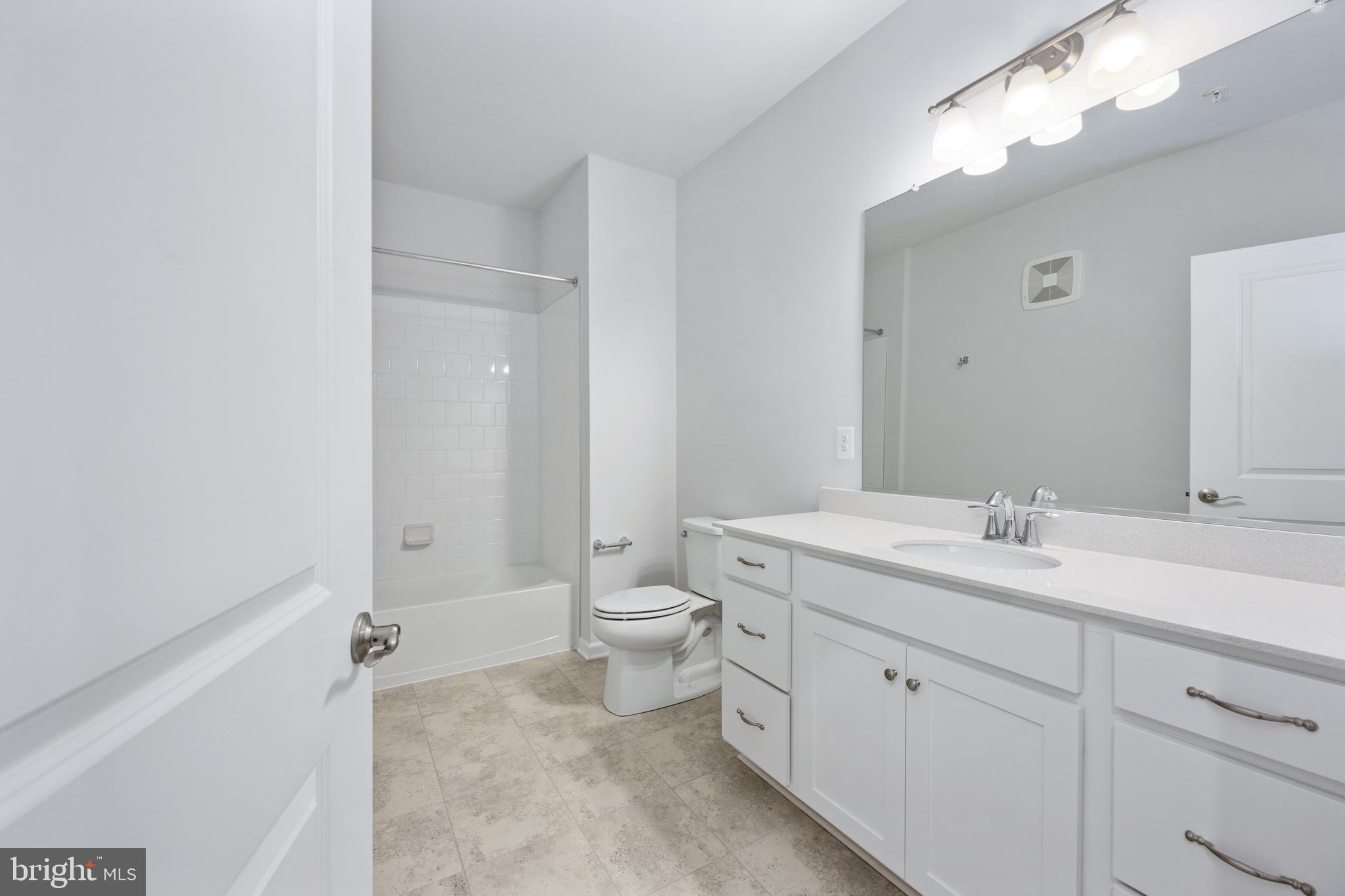 29 Hyssop Way, Unit 103 Stafford, VA 22554 - Photo 28 of 39 a spacious bathroom with a toilet sink and mirror