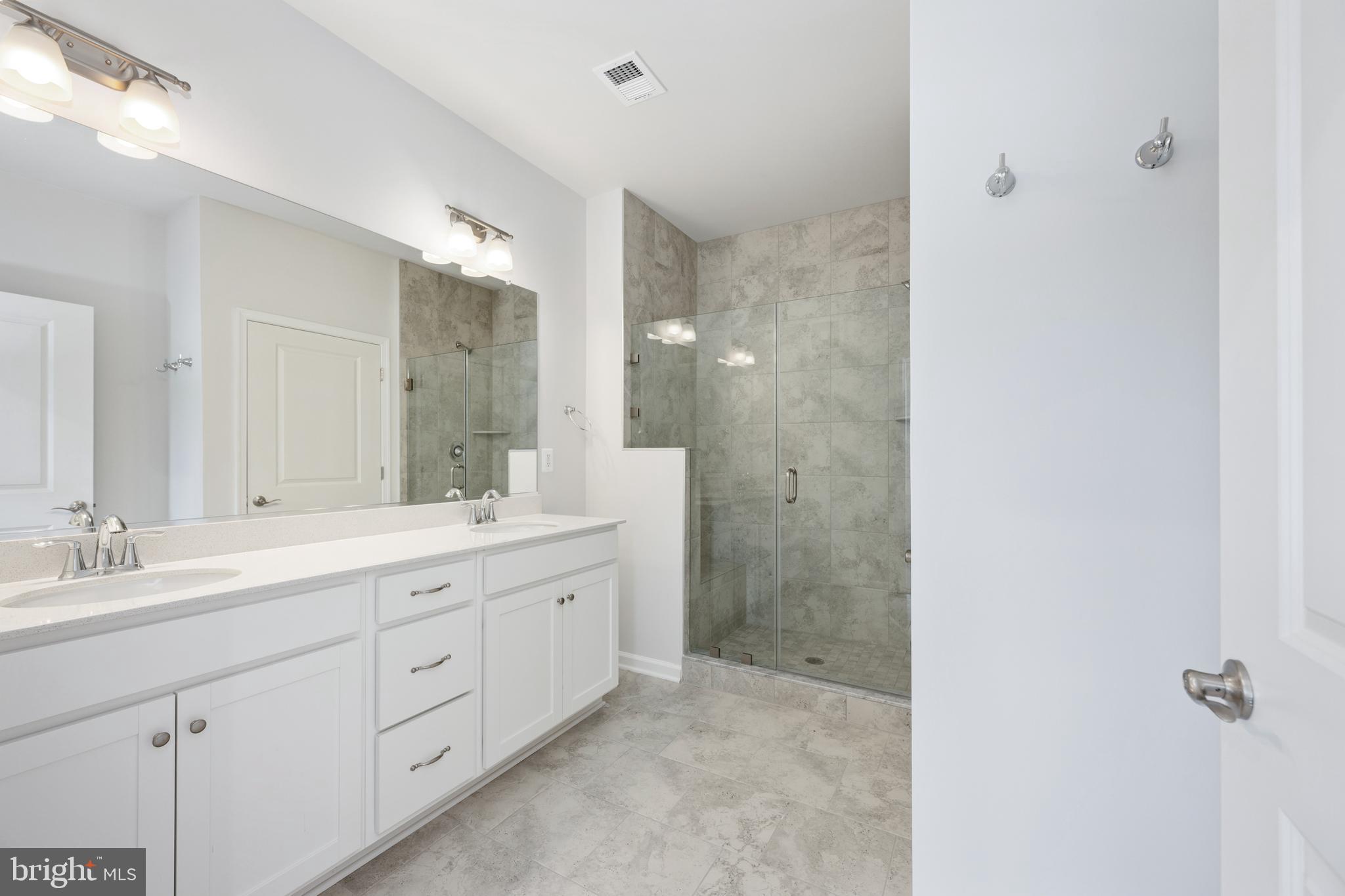 29 Hyssop Way, Unit 103 Stafford, VA 22554 - Photo 38 of 39 a spacious bathroom with a shower sink and mirror