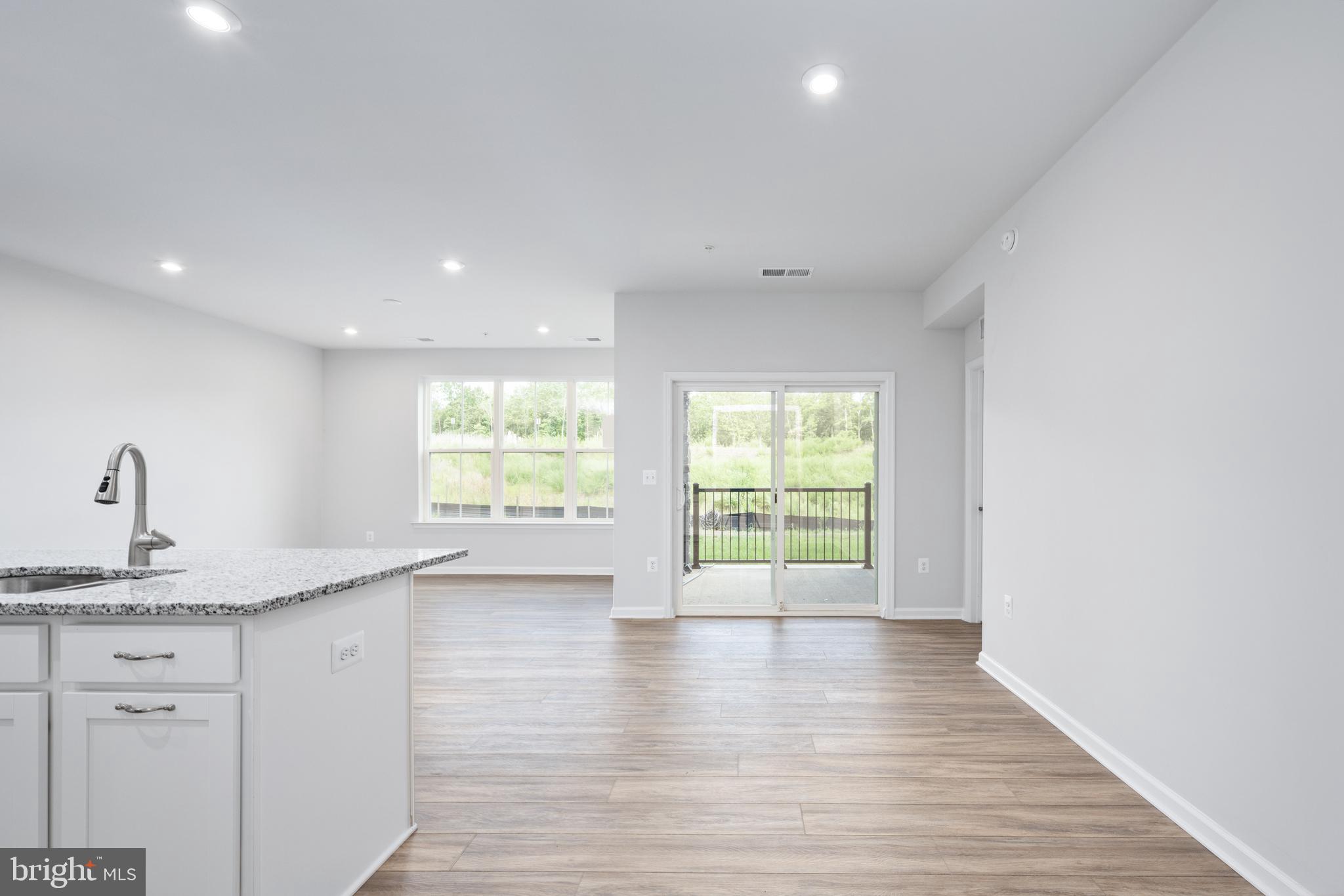 29 Hyssop Way, Unit 103 Stafford, VA 22554 - Photo 10 of 39 a view of an empty room with wooden floor and a window
