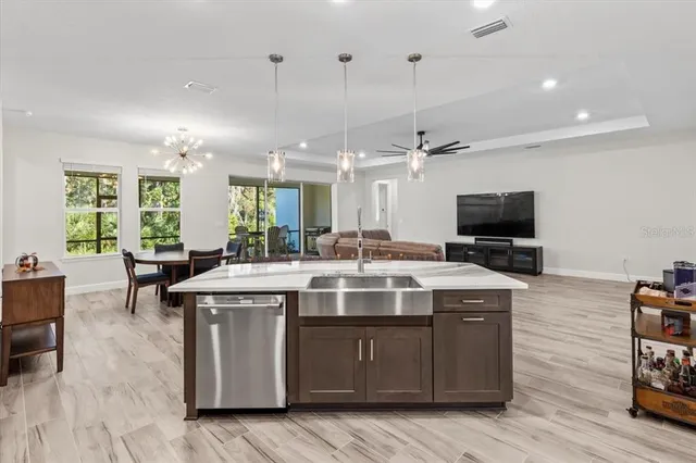 a living room with furniture a dining table and a fireplace
