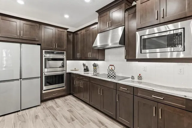 a bathroom with a double vanity sink a large mirror a bathtub and a shower