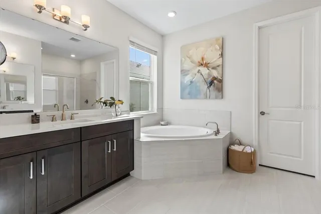 a bathroom with a sink a toilet and a large mirror