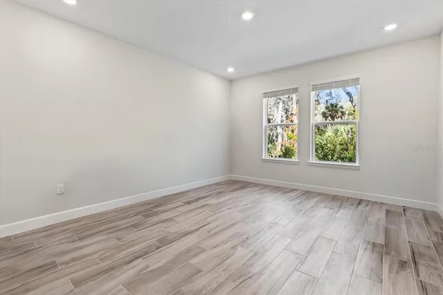 a view of a house with pool plants and large trees