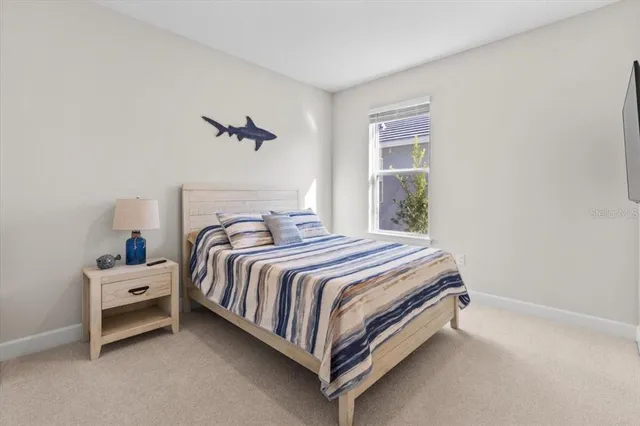 a sign that is sitting in the grass near a tree