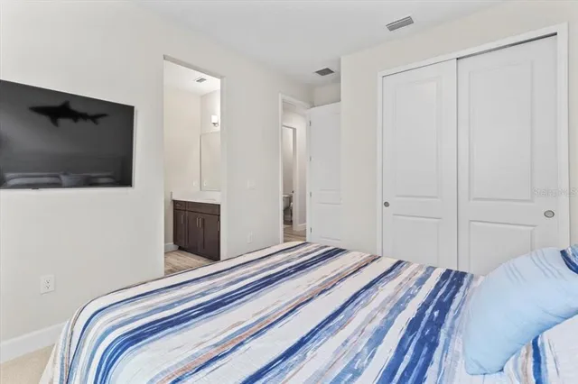 a sign that is sitting in front of a tree