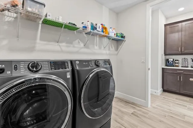 a view of a street with a bench and trees around