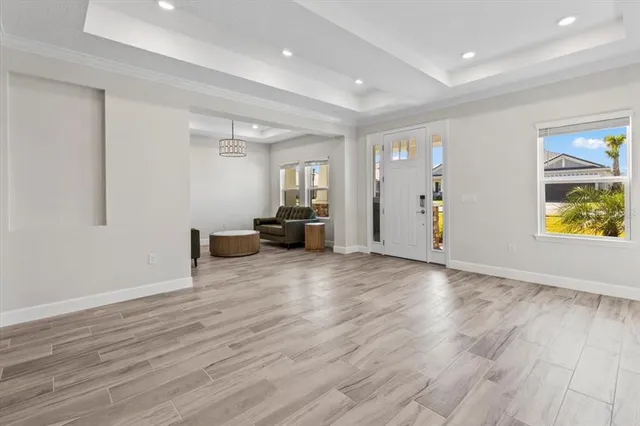 a kitchen with stainless steel appliances kitchen island granite countertop a sink refrigerator and cabinets