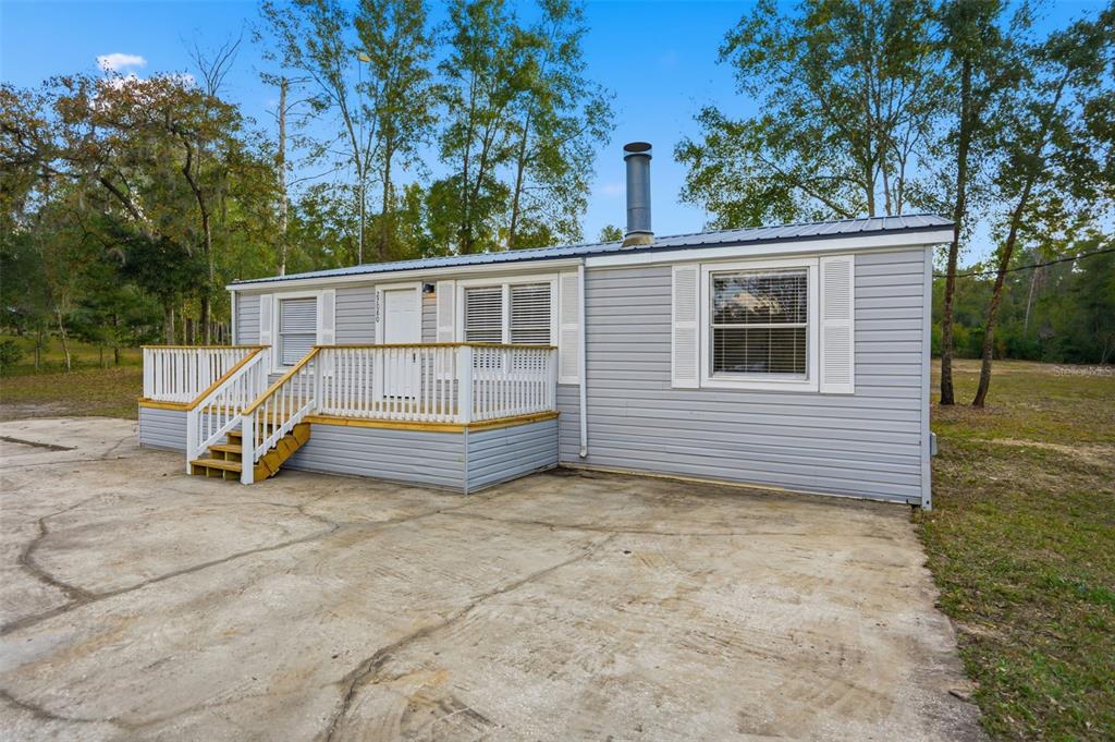 27080 Hiawatha Boulevard Brooksville, FL 34601 - Photo 13 of 39 a view of backyard with deck and outdoor seating
