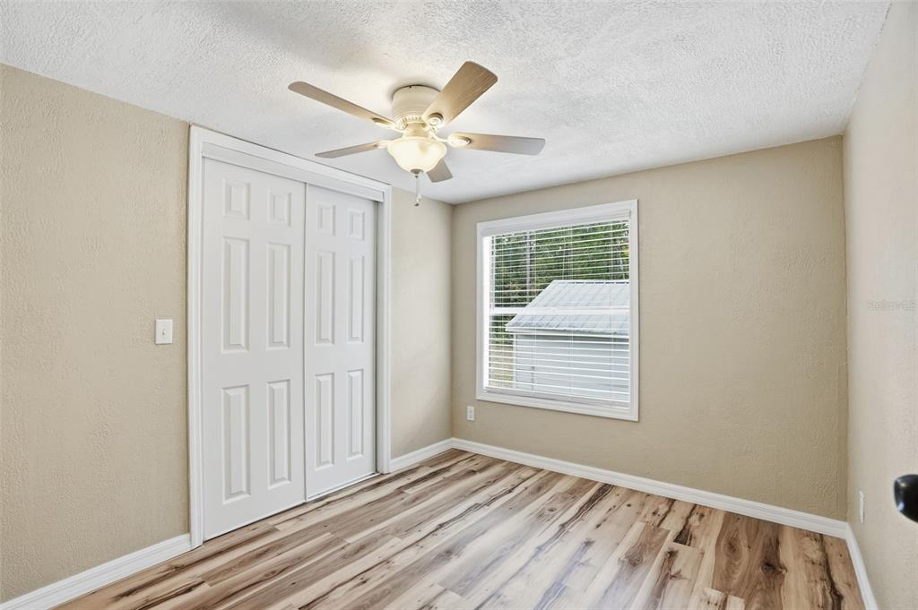 27080 Hiawatha Boulevard Brooksville, FL 34601 - Photo 23 of 39 a view of an empty room with wooden floor and a window