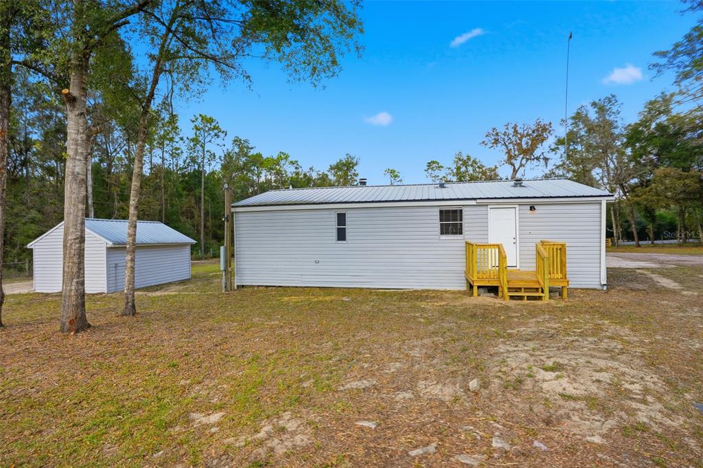 27080 Hiawatha Boulevard Brooksville, FL 34601 - Photo 27 of 39 a view of a house with backyard and a tree