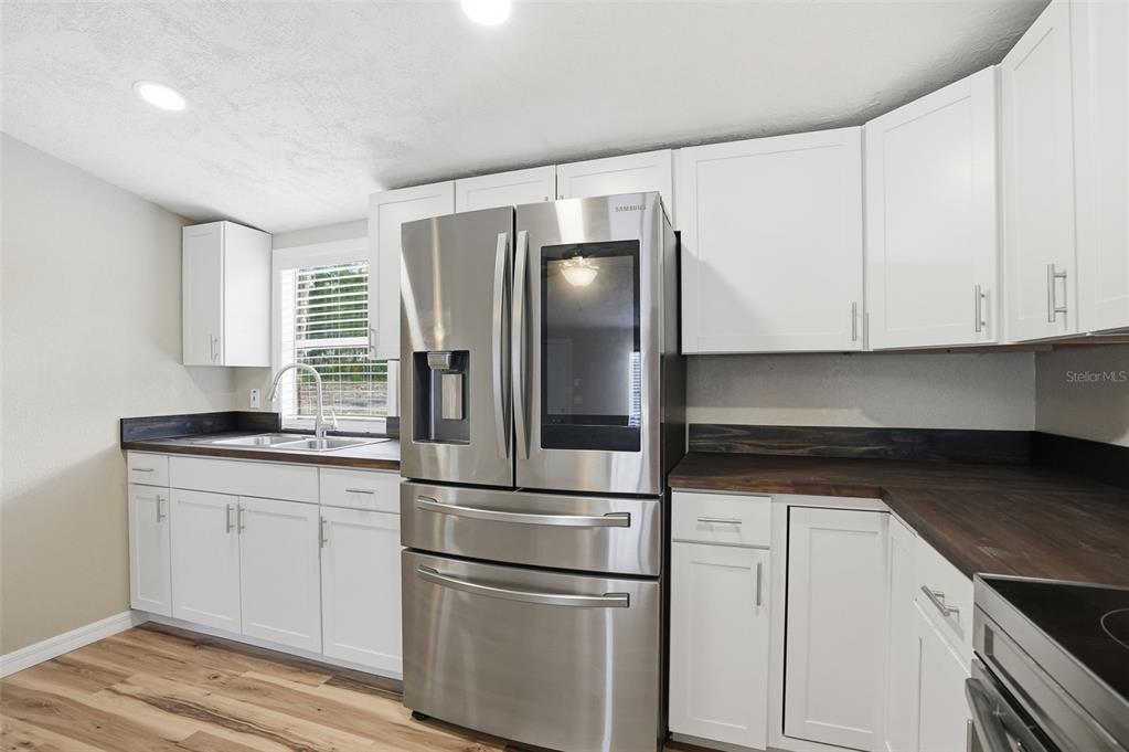 27080 Hiawatha Boulevard Brooksville, FL 34601 - Photo 5 of 39 a kitchen with stainless steel appliances granite countertop a refrigerator and a stove top oven
