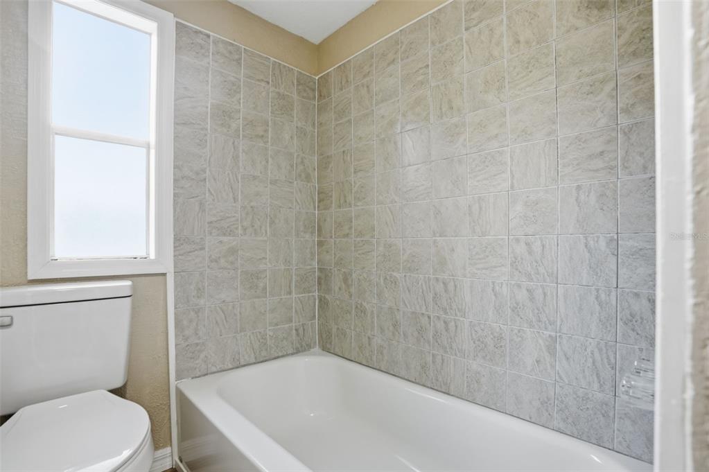 27080 Hiawatha Boulevard Brooksville, FL 34601 - Photo 8 of 39 a bath tub sitting next to a white toilet