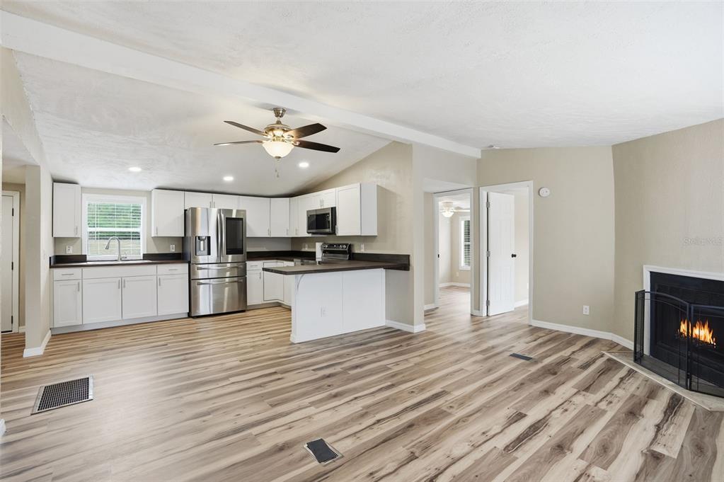 27080 Hiawatha Boulevard Brooksville, FL 34601 - Photo 9 of 39 a kitchen with a refrigerator and white cabinets