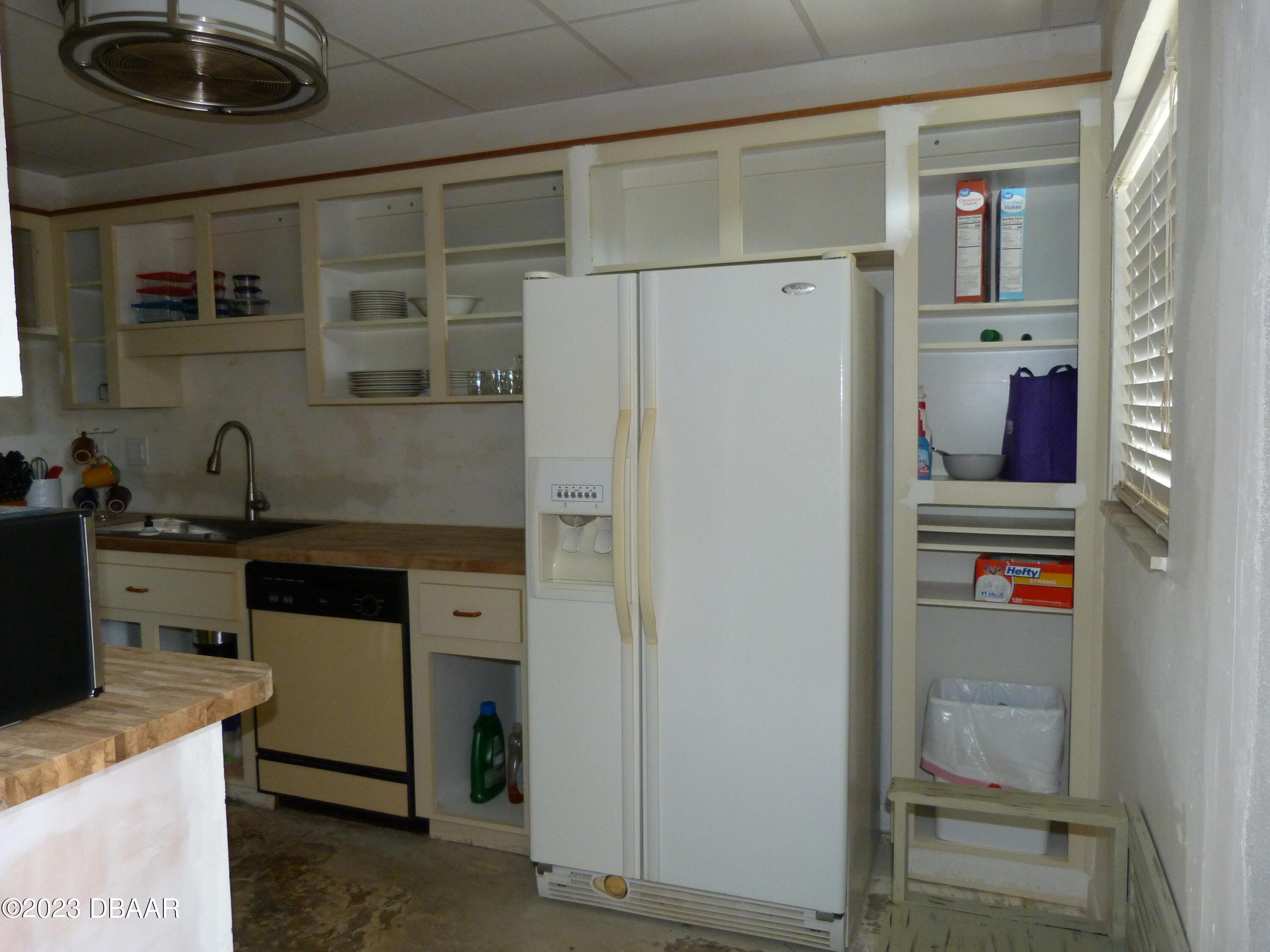 640 North Nova Road, Unit 303 Ormond Beach, FL 32174 - Photo 12 of 31 a kitchen with a refrigerator and a sink