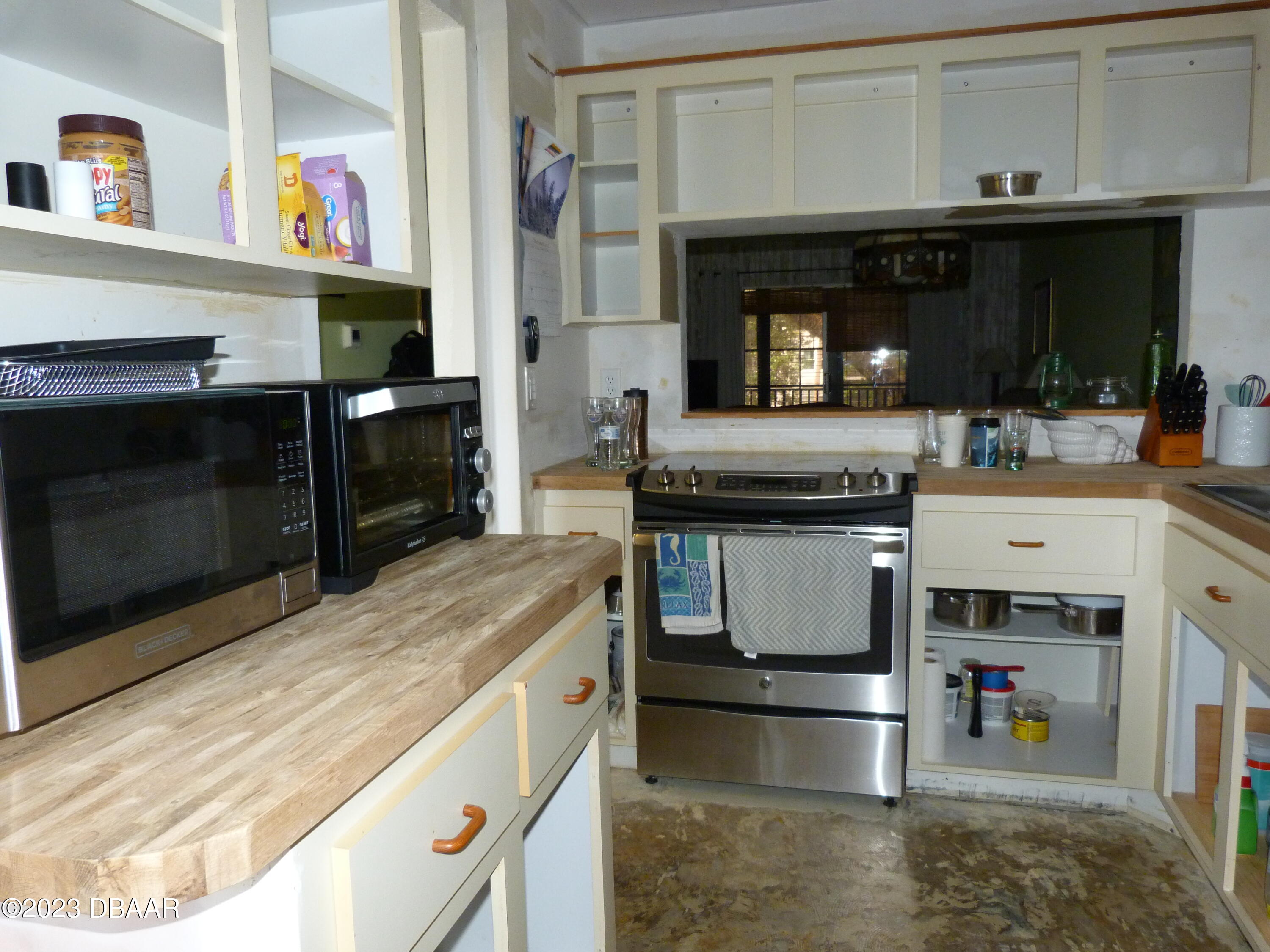 640 North Nova Road, Unit 303 Ormond Beach, FL 32174 - Photo 14 of 31 a kitchen with a stove and a microwave