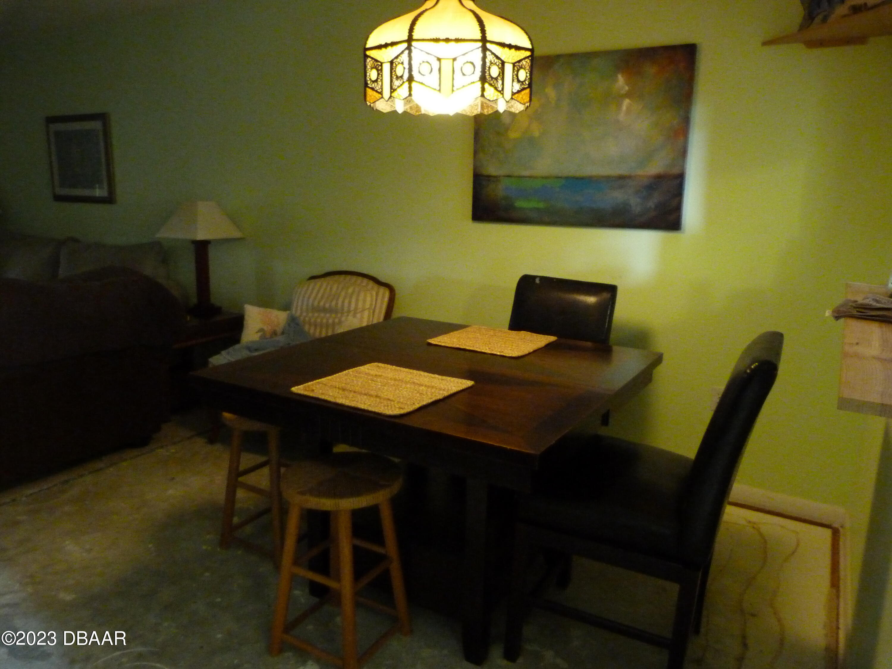 640 North Nova Road, Unit 303 Ormond Beach, FL 32174 - Photo 17 of 31 a view of a dining room with furniture and a wooden floor