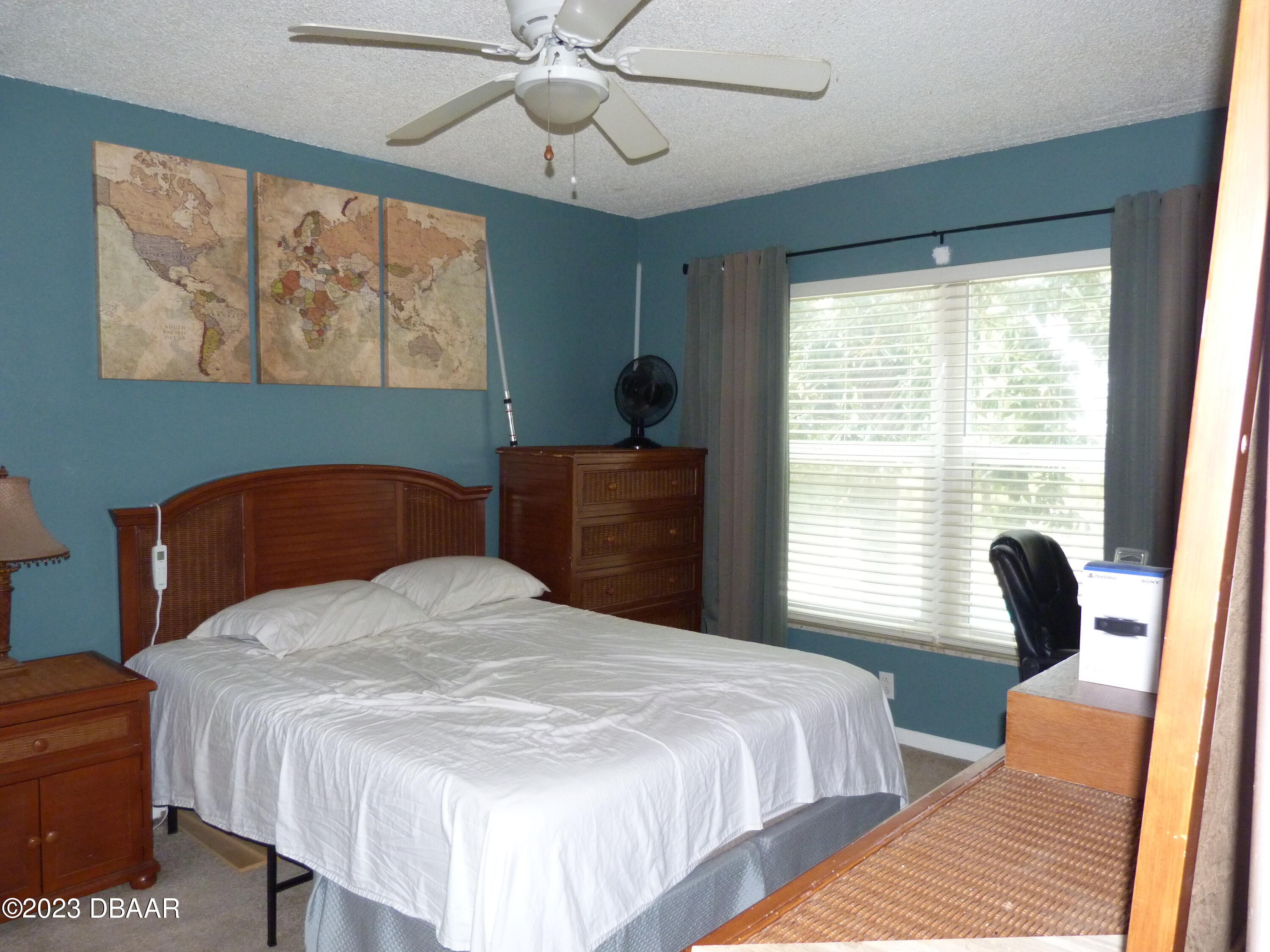 640 North Nova Road, Unit 303 Ormond Beach, FL 32174 - Photo 21 of 31 a bedroom with a bed and wooden floor