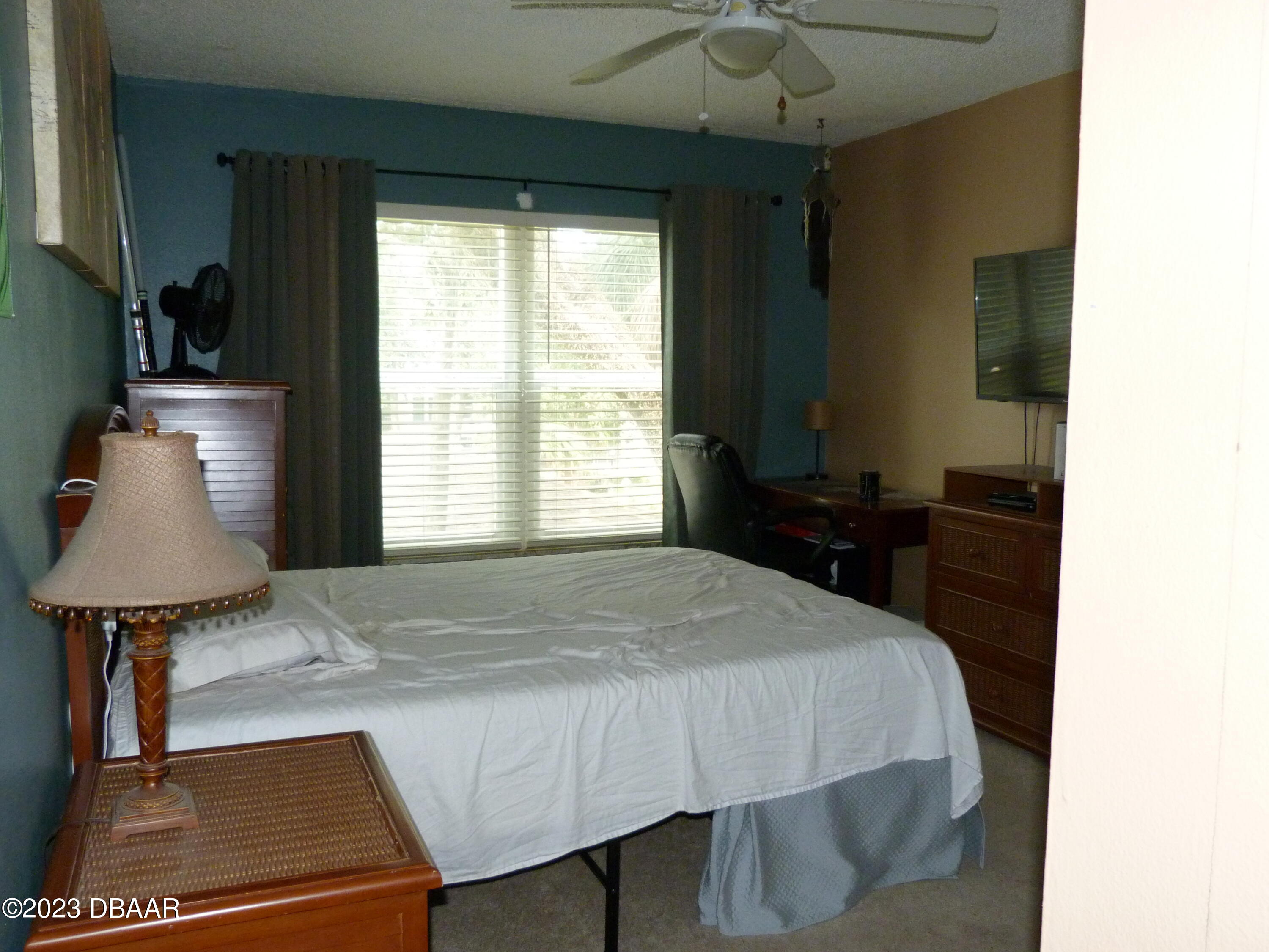 640 North Nova Road, Unit 303 Ormond Beach, FL 32174 - Photo 22 of 31 a bed sitting in a bedroom next to a window
