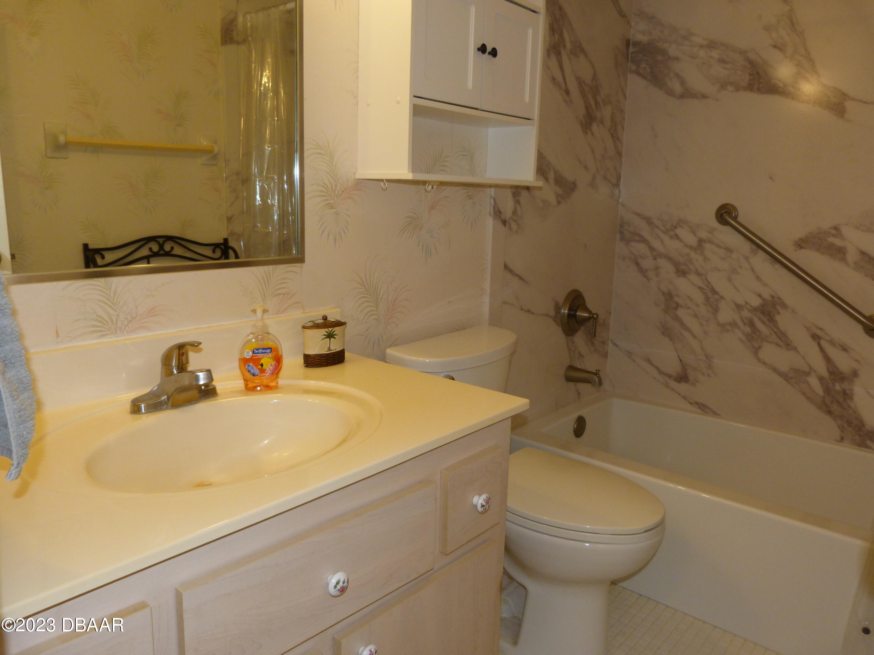 640 North Nova Road, Unit 303 Ormond Beach, FL 32174 - Photo 28 of 31 a bathroom with a sink a toilet and bathtub