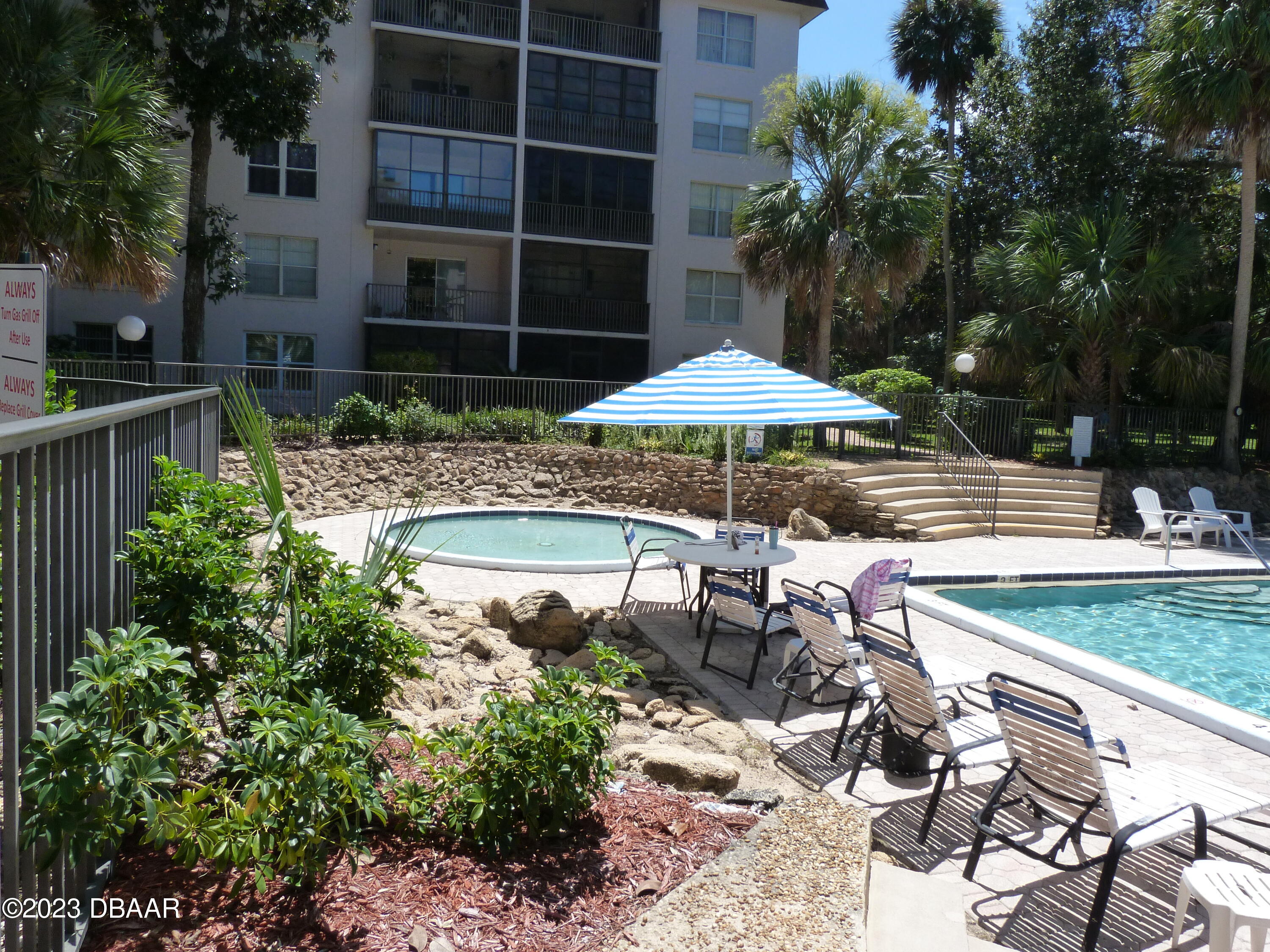 640 North Nova Road, Unit 303 Ormond Beach, FL 32174 - Photo 5 of 31 a view of backyard with swimming pool and outdoor seating