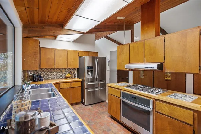 a kitchen with sink a large window and a counter top space