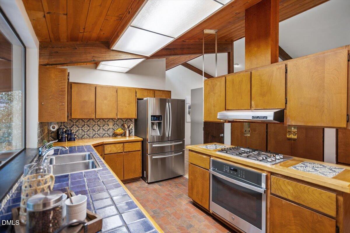 2903 Montgomery Street Durham, NC 27705 - Photo 14 of 37 a kitchen with a stove and a refrigerator