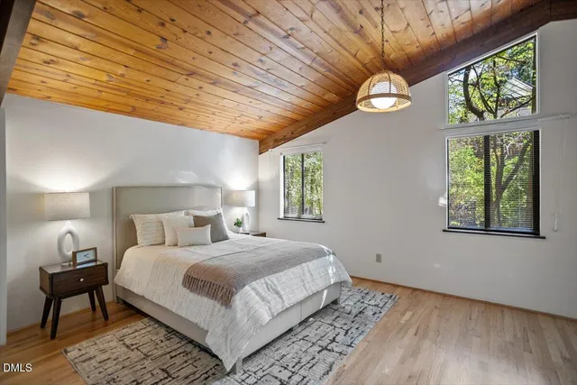 a view of a room with a large window wooden floor