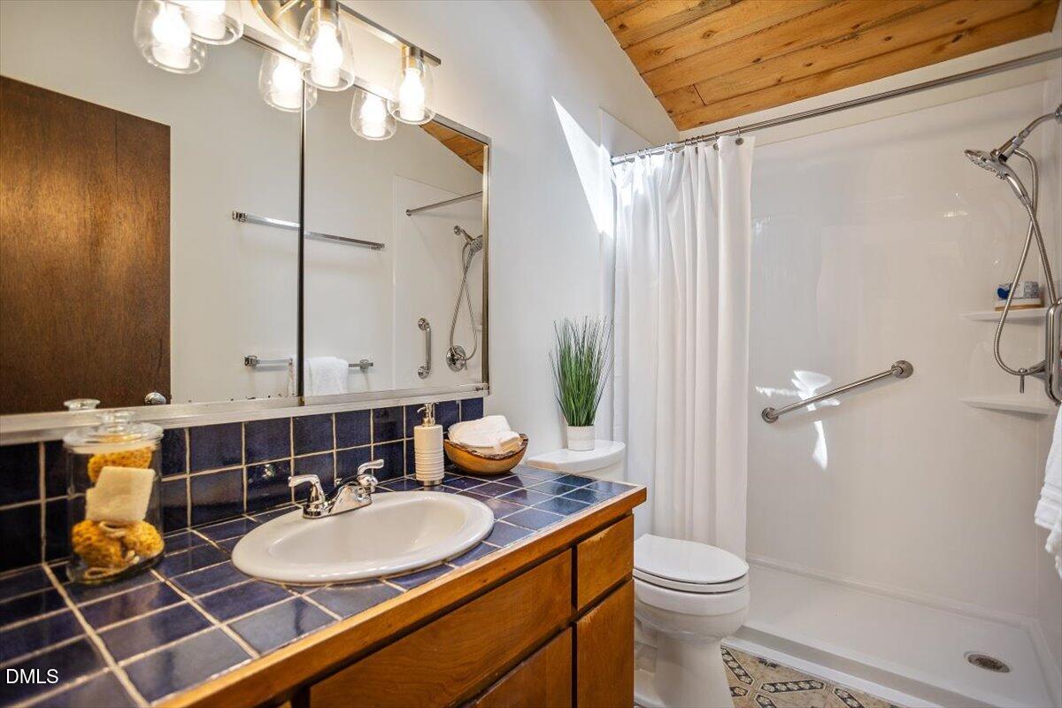2903 Montgomery Street Durham, NC 27705 - Photo 23 of 37 a bathroom with a double vanity sink toilet and shower