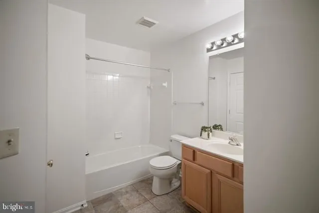a bathroom with a toilet a bath tub and a sink