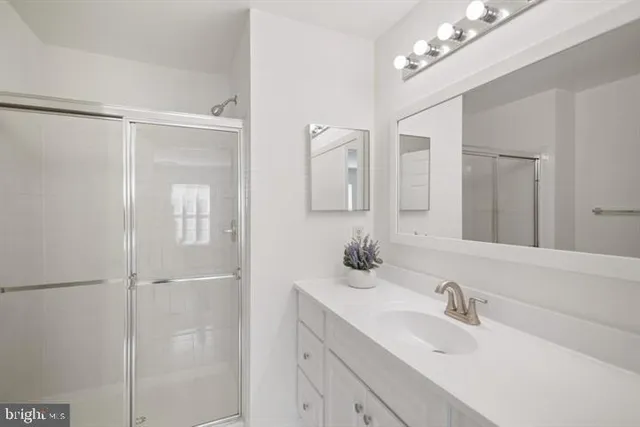 a bathroom with a sink double vanity and a mirror