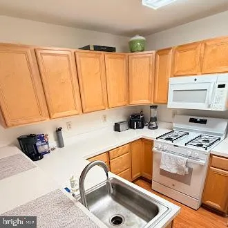a kitchen with a sink a stove and cabinets