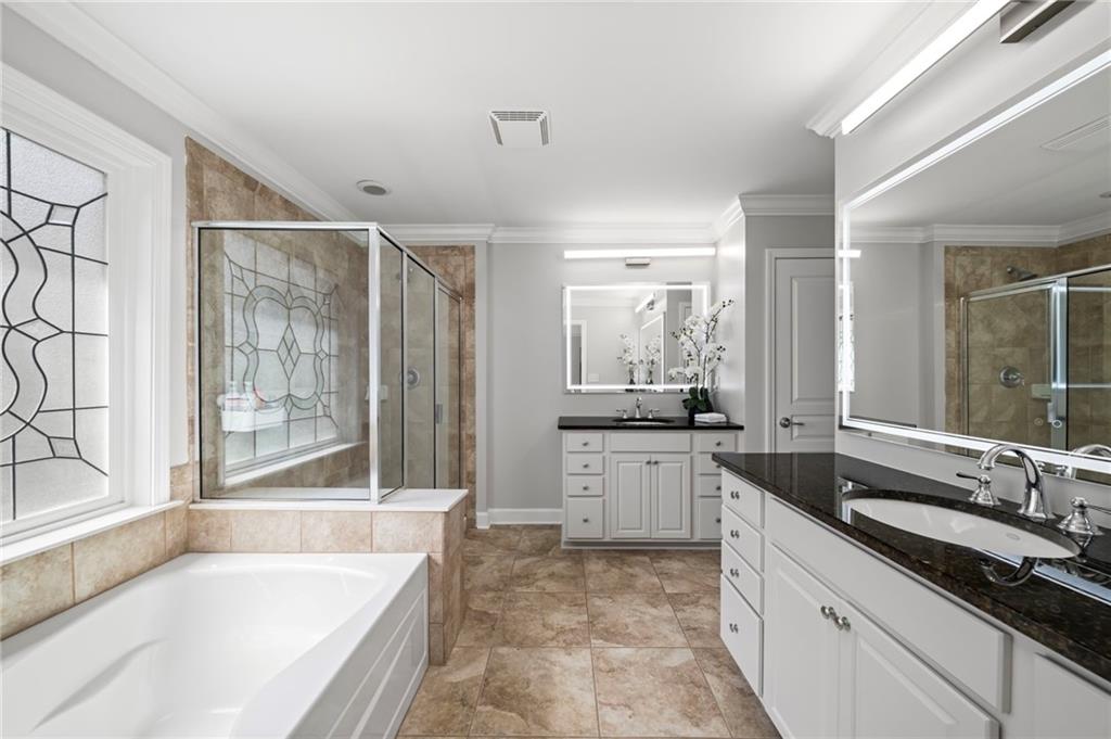 2872 Overlook Way Northeast Atlanta, GA 30324 - Photo 20 of 47 a large bathroom with a granite countertop tub sink shower and mirror